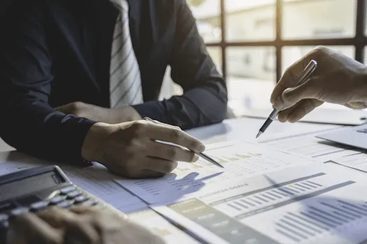 Two businessmen looking at reports